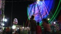 Illuminated lights of swings, long shutter of Ferris wheel Royalty Free Stock Photo