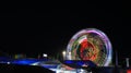 Illuminated lights of swings, long shutter of Ferris wheel Royalty Free Stock Photo