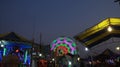 Illuminated lights of swings, long shutter of Ferris wheel Royalty Free Stock Photo