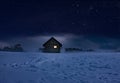 Illuminated log cabin in winter night Royalty Free Stock Photo