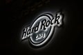 Krakow, Poland - 18 July 2016: Illuminated logo of the famous Hard Rock Cafe restaurant chain, which shines at night on the buildi