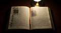 Illuminated Manuscript Open Under Light Antique Text and Artwork Royalty Free Stock Photo