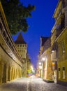 illuminated medieval defense wall and The Carpenters' Tower in Sibiu city during night, Transylvania region, Romania Royalty Free Stock Photo