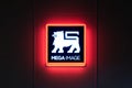 Illuminated Mega Image logo sign at night. Mega Image is a supermarket chain, established in Romania in 1995