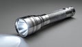 Illuminated Metal Flashlight on a Gray Background Royalty Free Stock Photo