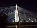 Illuminated modern cable-stayed bridge over the river in the night city Royalty Free Stock Photo