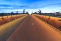 Illuminated modern style build decorative rusty bridge for pedestrians and cyclists during dusk