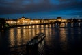 Illuminated Moldova River With Ship And Historic Buildings In The Night In Prague In The Czech Republic Royalty Free Stock Photo