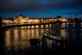 Illuminated Moldova River With Ship And Historic Buildings In The Night In Prague In The Czech Republic Royalty Free Stock Photo