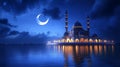 Illuminated mosque at night reflected in calm waters under a crescent moon