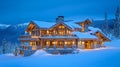 Illuminated Mountainside Lodge with Snow-Covered Roof and Icicles Royalty Free Stock Photo