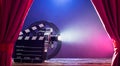 Movie Camera With Clapperboard And Film Reel On Stage Royalty Free Stock Photo