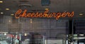 An illuminated neon Cheeseburger sign