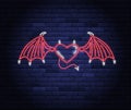 Illuminated neon heart with devil wings