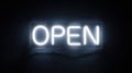 Illuminated Neon Open Sign Glowing in the Dark with a Cool White Light Texture Royalty Free Stock Photo