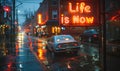 Illuminated neon sign in a rainy cityscape boldly declaring Life is Now, emphasizing the concept of living in the moment and Royalty Free Stock Photo