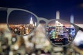 Illuminated night city view through eyeglasses Royalty Free Stock Photo