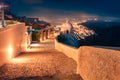 Illuminated night scene of Santorini island. Amazing spring scene of famous Greek resort Thira, Greece Royalty Free Stock Photo