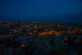 Illuminated at night streets of Goreme, Turkey, Cappadocia. The famous center of flight balloons. On the horizon - highlighted