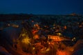 Illuminated at night streets of Goreme, Turkey, Cappadocia. On the horizon - Uchisar. Amazing night landscape Royalty Free Stock Photo