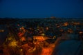 Illuminated at night streets of Goreme, Turkey, Cappadocia. On the horizon - Uchisar. Amazing night landscape