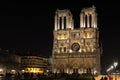 Illuminated Notre Dame cathedral night view, Paris, France. Tourists landmark