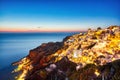 Illuminated Oia Village at Sunset on Santorini Island Royalty Free Stock Photo