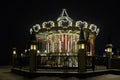 Illuminated old-fashioned carousel in a shopping and entertainment center in Moscow, night view. Royalty Free Stock Photo
