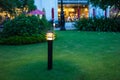 Illuminated outdoor light in apartment garden at twilight, evening. Royalty Free Stock Photo