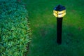 Illuminated outdoor light in apartment garden at twilight, evening. Royalty Free Stock Photo