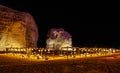 Illuminated outdoor lounge in front of elephant rock erosion monolith standing in the night desert, Al Ula, Saudi Arabia Royalty Free Stock Photo