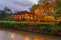 Illuminated outdoor restaurant by river