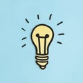 illuminated paper cutout yellow light bulb blue background. High quality photo Royalty Free Stock Photo