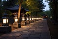 illuminated path lined with stone lanterns