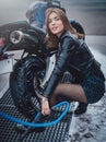 A nice looking female driver and her modern motorbike in carwash Royalty Free Stock Photo