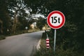 Illuminated photo of road sign 15 tons with bridge and way throught the forest on background. Road Traffic sign of mass