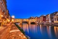 Illuminated Ponte Vecchio Bridge with Reflection in Arno River at Dusk, Florence