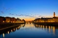 Illuminated Ponte Vecchio with reflections at dusk, Florence, Tuscany, Italy