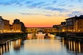 Illuminated Ponte Vecchio with reflections at sunset, Florence, Tuscany, Italy