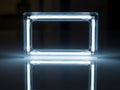 Illuminated rectangular light frame reflecting on a dark, glossy surface Royalty Free Stock Photo