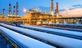 Illuminated refinery pipelines and complex structures at twilight Royalty Free Stock Photo