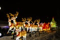 Illuminated reindeer pulling Santa sleigh lantern display Royalty Free Stock Photo
