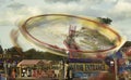 Illuminated, rotating swing ride at a funfair. 2