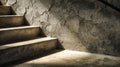 Illuminated rough concrete staircase casting dynamic shadows against textured wall in dimly lit industrial interior setting with Royalty Free Stock Photo