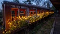 Illuminated Rusty Train Carriage with Flowers at Night Royalty Free Stock Photo