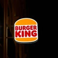 Illuminated sign for the fast food chain Burger King in the center of Prague