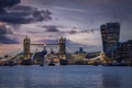 The illuminated skyline of London with a big cruise ship passing under the lifted Tower Bridge Royalty Free Stock Photo