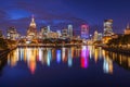 Illuminated skyline mirrored in river with vibrant colors Royalty Free Stock Photo