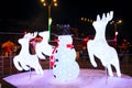 Illuminated snowman with christmas deers