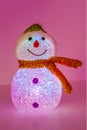 Illuminated snowman on pink background